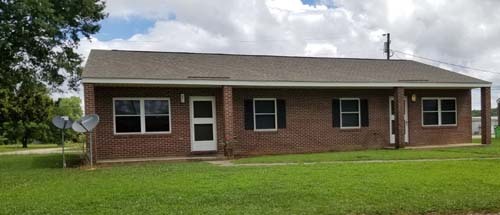 A close view of a housing unit with a grassy yard. 