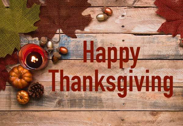 Happy Thanksgiving banner with leaves and pumpkins in background