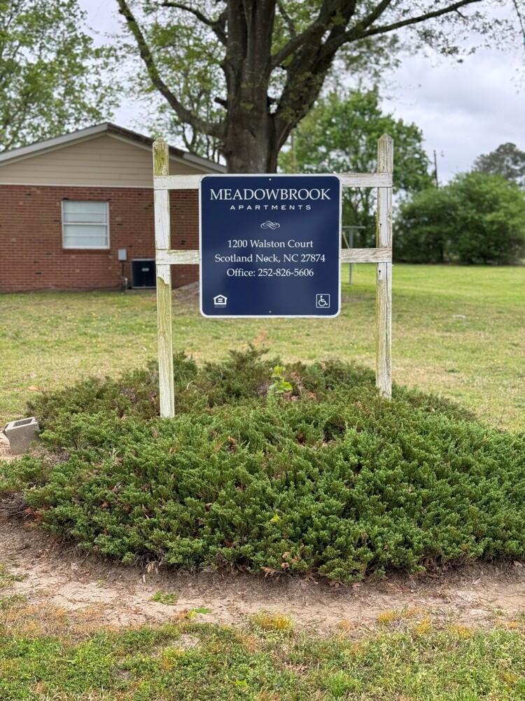 Meadowbrook apartments sign. 1200 Watson Court. Scotland Neck, NC 27874. Office 252-826-5606.