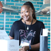 A lady standing at the raffle ticket counter.