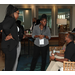 People standing in a room visiting with each other.