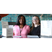 Two ladies standing at the raffle ticket counter.