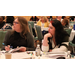 Two people sitting at a table working on the paperwork for the presentation.