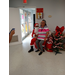 A lady sitting on Santa's lap at the cookie and cocoa event.