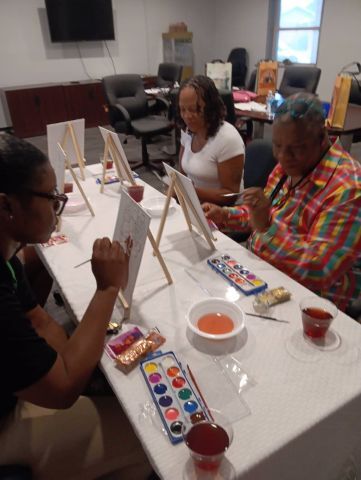 PaintParty1Small.jpg Three women sit around a table painting.