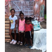  Three kids smiling for a picture. 