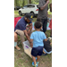  A child reaches into a bucket. 