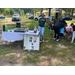  People standing behind a table. 