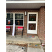  Front porch view showing a door and window decorated with Christmas decorations. 