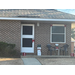  A brick house decorated with Christmas bows and decorations. 